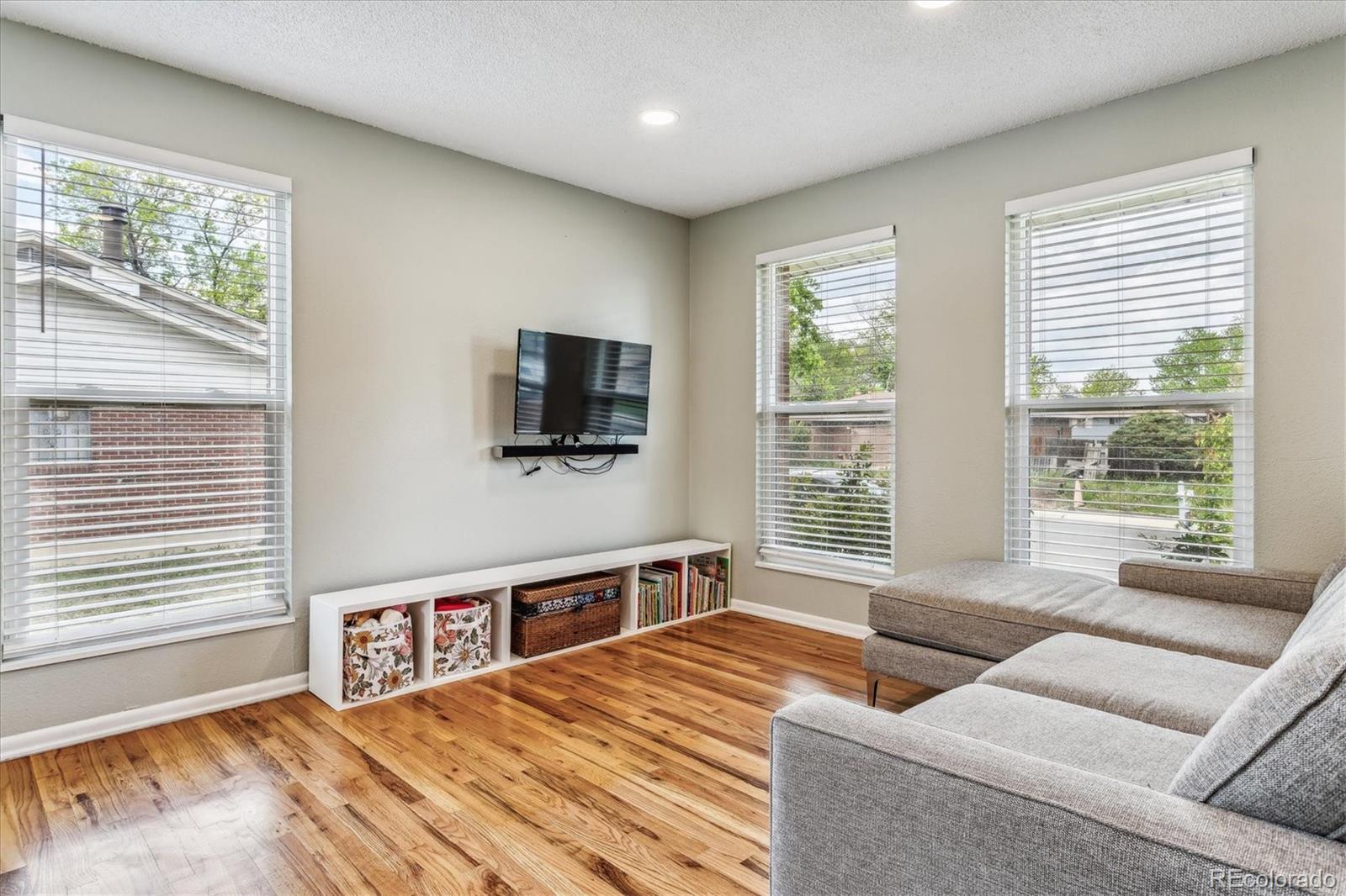 4844 Scranton Court Denver, CO 80239 - Photo 9 of 25 a bedroom with furniture and a flat screen tv