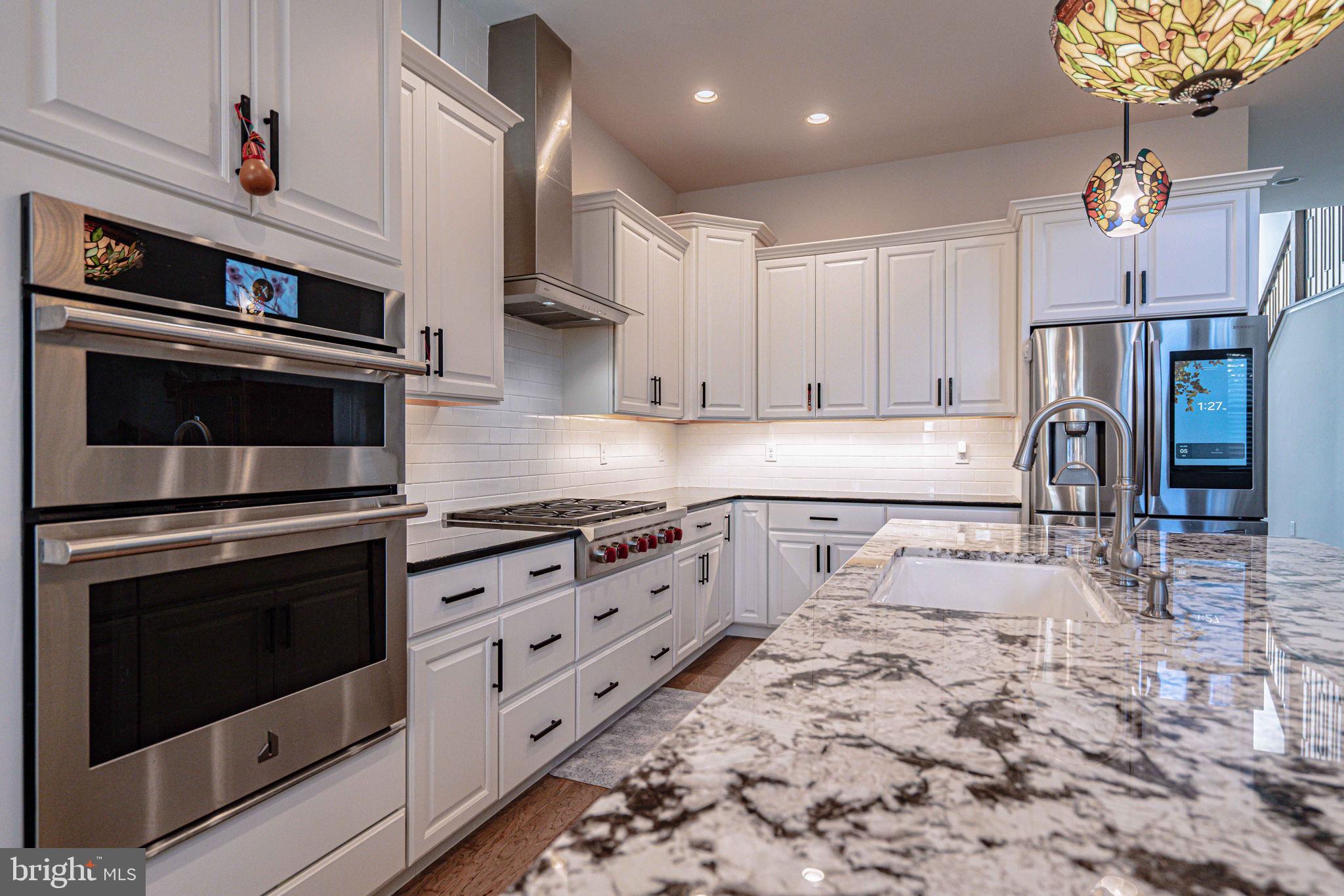 4027 Shef's Way Allentown, PA 18104 - Photo 19 of 80 a kitchen with stainless steel appliances granite countertop a stove a sink and a refrigerator