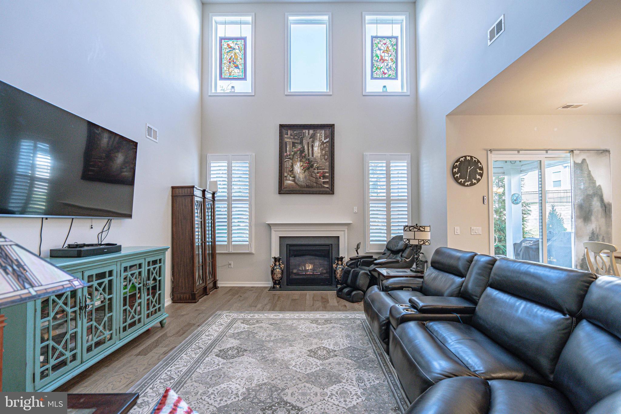 4027 Shef's Way Allentown, PA 18104 - Photo 28 of 80 a living room with furniture a flat screen tv and a fireplace
