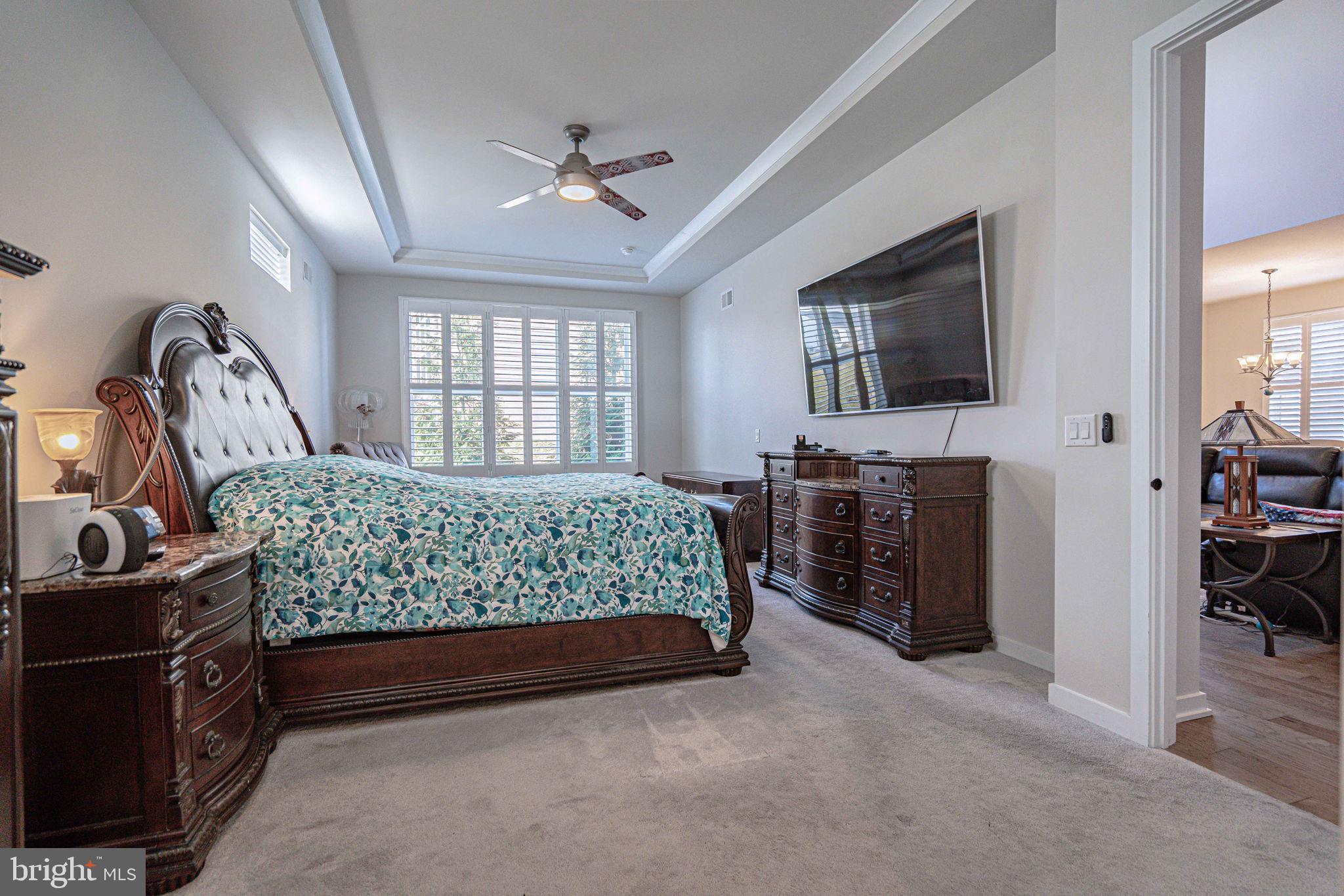 4027 Shef's Way Allentown, PA 18104 - Photo 31 of 80 a bedroom with a bed and a flat tv screen on the dresser