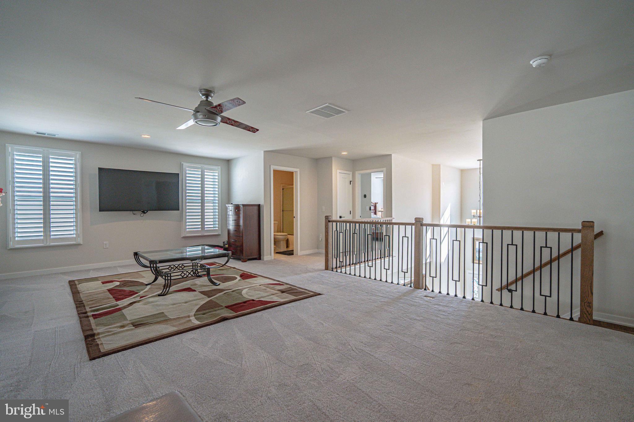 4027 Shef's Way Allentown, PA 18104 - Photo 38 of 80 a living room with furniture flat screen tv and a ceiling fan