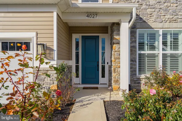 a view of a hallway with wooden floor and entryway