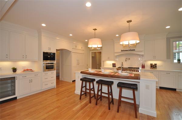36 Somerset Road Lexington, MA 02420 - Photo 8 of 22 a kitchen with kitchen island granite countertop a sink and a stove in it