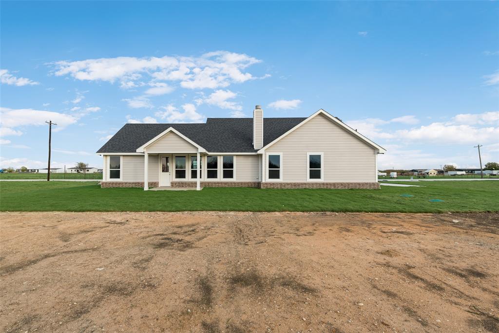 1230 County Road 200 Valley View, TX 76272 - Photo 22 of 26 View of front of house featuring a front lawn, a chimney, and a shingled roof