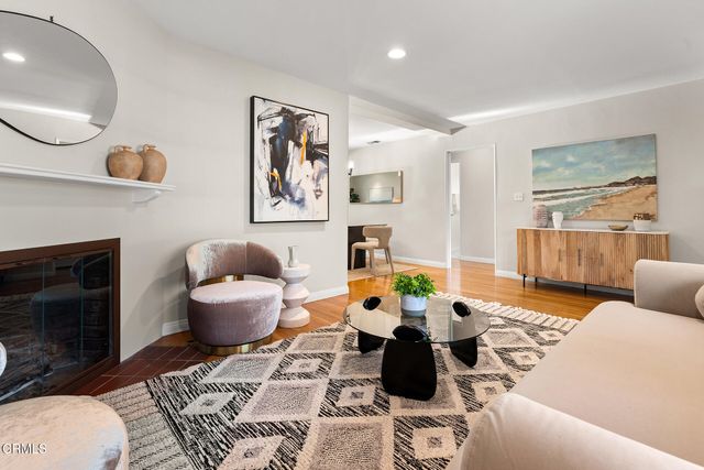 a living room with furniture a rug and a fireplace