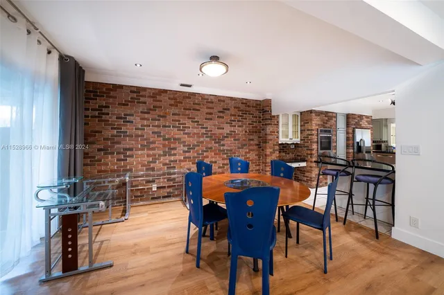 a dining room with furniture and wooden floor