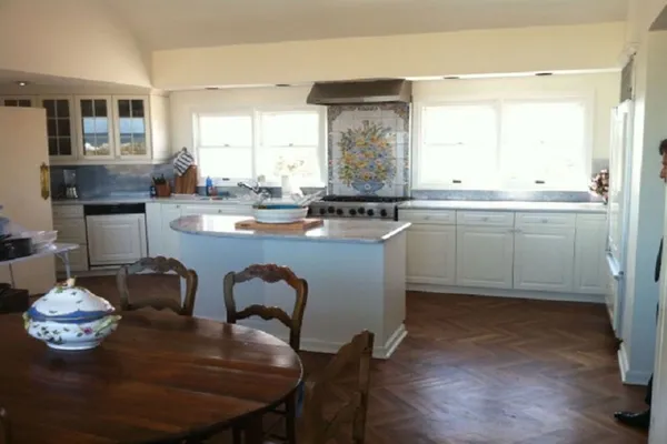 a kitchen with a table chairs stove and microwave