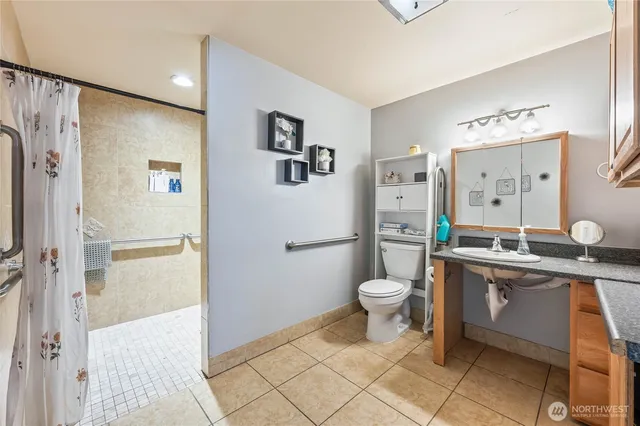 a bathroom with a toilet sink and mirror