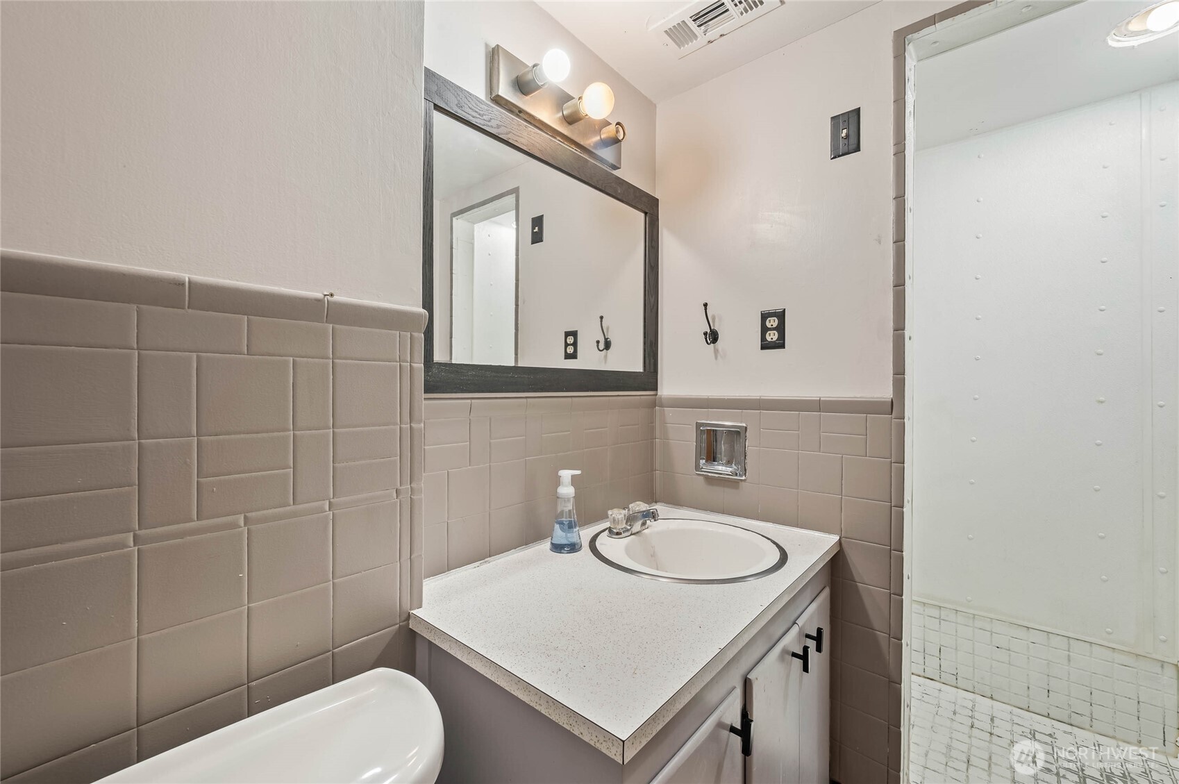 33 North Furney Street Wenatchee, WA 98801 - Photo 19 of 22 a bathroom with a sink a toilet and mirror