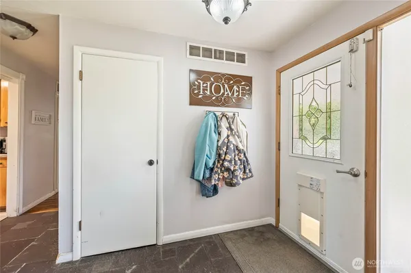 a view of an entryway with wooden floor