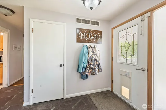 a view of an entryway with wooden floor