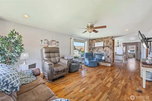 a living room with furniture ceiling fan and a rug