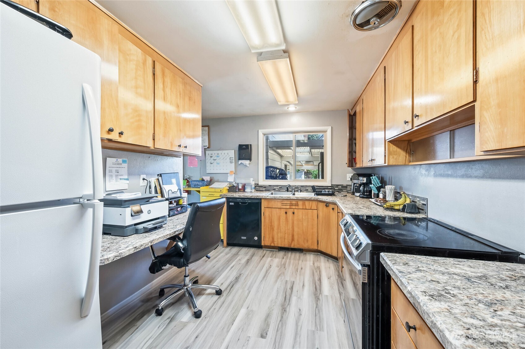 33 North Furney Street Wenatchee, WA 98801 - Photo 8 of 22 a kitchen with a sink a stove and cabinets