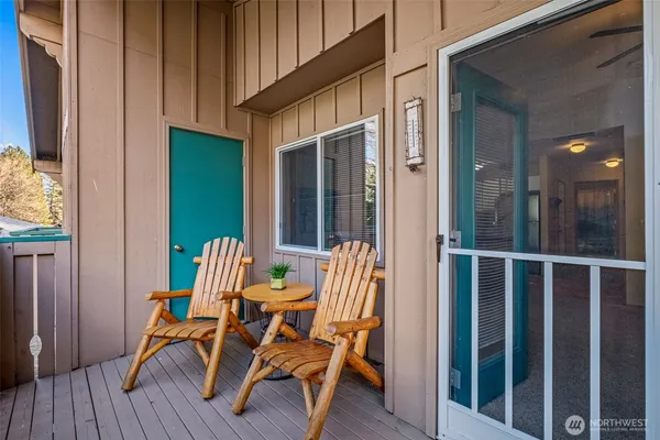 a view of two chairs in the balcony