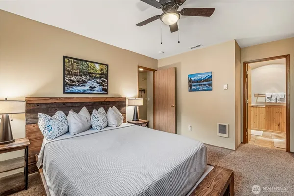 a bedroom with a large bed and a chandelier