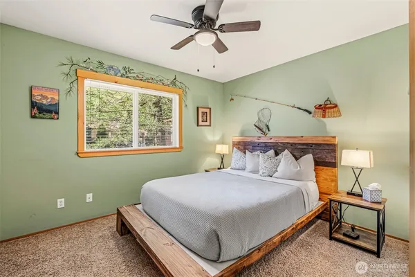 a bedroom with a bed and a chandelier