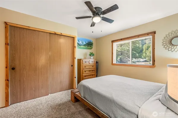 a bedroom with a large bed and a window