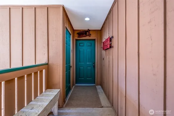 a view of a hallway with wooden floor and stairs