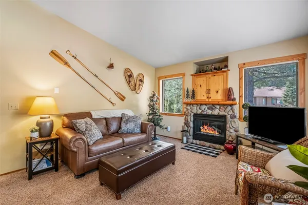 a living room with furniture a flat screen tv and a fireplace