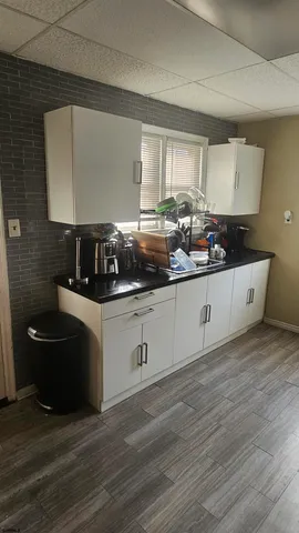 a kitchen with a sink and cabinets