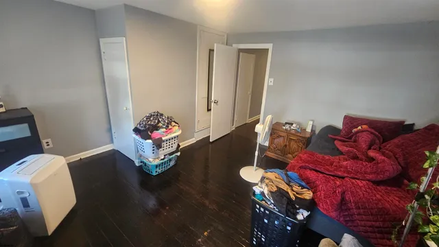 a view of an empty room and wooden floor