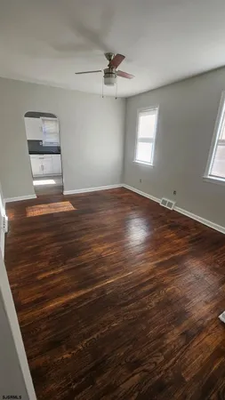 wooden floor in an empty room with a window