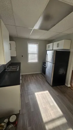 a kitchen with a refrigerator and a stove top oven
