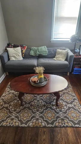 a living room with furniture and a rug