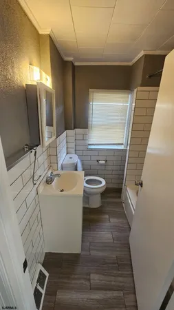 a bathroom with a sink a toilet and mirror