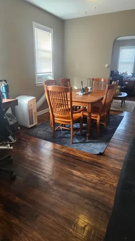 a dining room with furniture and wooden floor