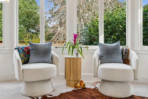 a bedroom with furniture and a large window