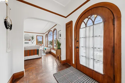 a dining room with furniture a chandelier and wooden floor