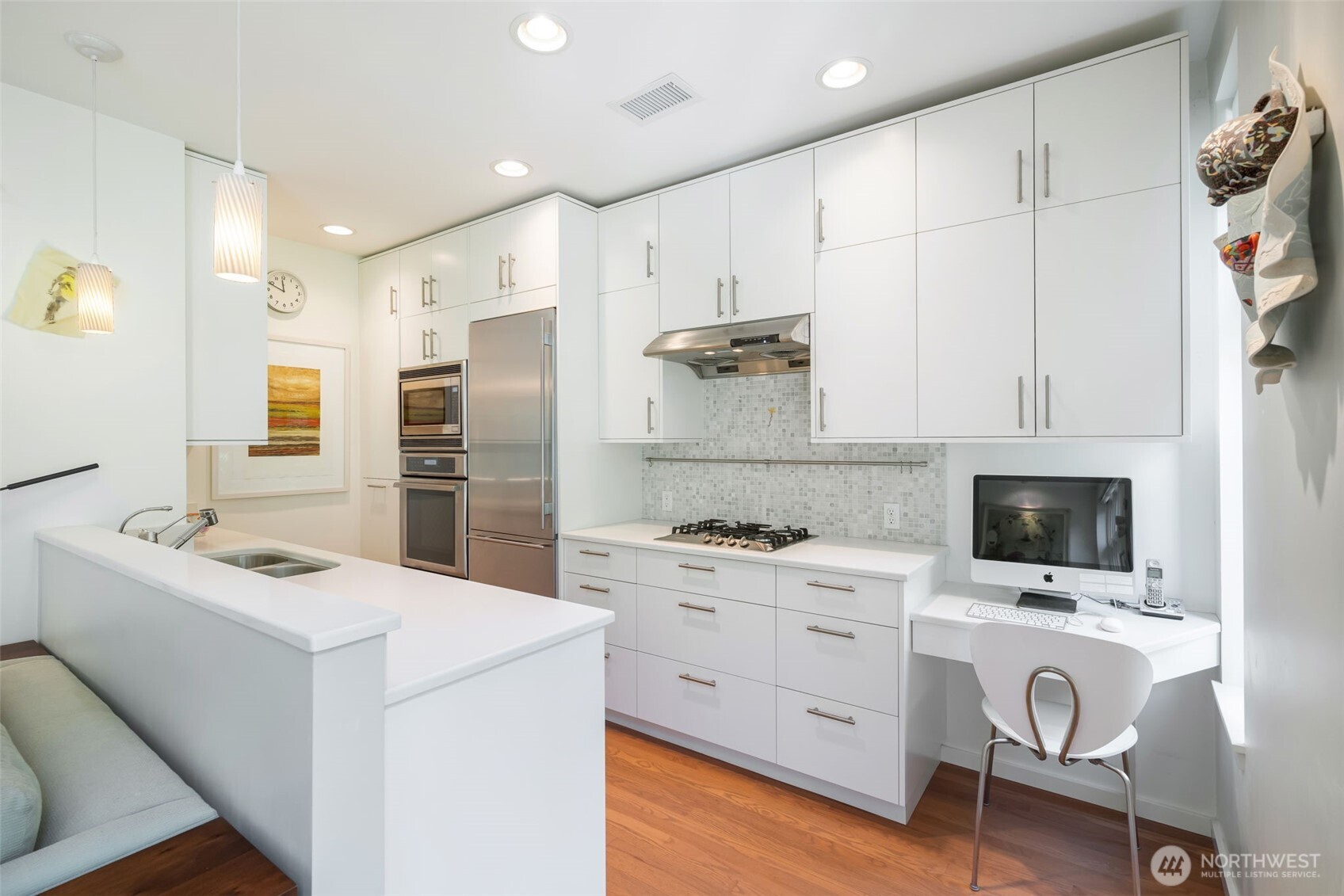 3601 South McClellan Street, Unit 8 Seattle, WA 98144 - Photo 14 of 23 a kitchen with white cabinets and stainless steel appliances