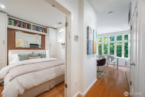 a bedroom with a bed and a large window