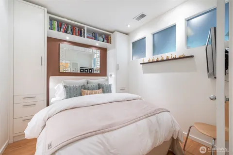 a bedroom with a bed and a book shelf