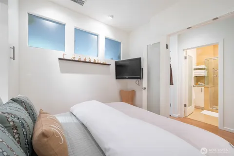 a bedroom with a bed and a flat screen tv