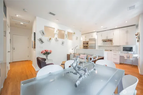 a living room with furniture and a chandelier
