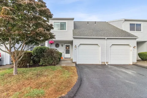 a view of a house with a yard and garage