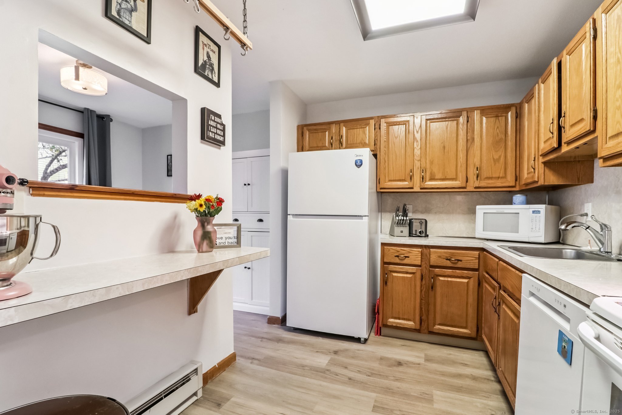 565 Clark Avenue, Unit 18 Bristol, CT 06010 - Photo 11 of 25 a kitchen with stainless steel appliances a refrigerator a sink and white cabinets