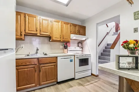 a kitchen with a sink cabinets and window
