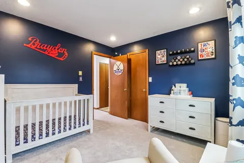 a bedroom with a bed and a dresser