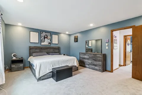 a bedroom with a bed and a television