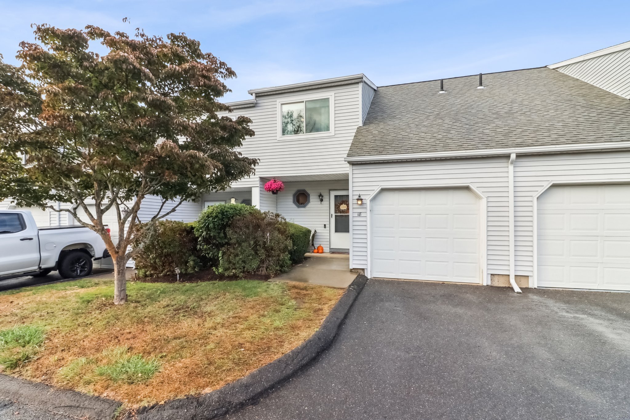 565 Clark Avenue, Unit 18 Bristol, CT 06010 - Photo 2 of 25 a view of a house with a yard and garage
