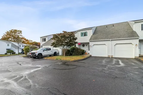 a view of a house with a parking space and parking