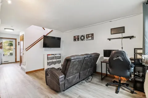 a livingroom with workspace and a couch