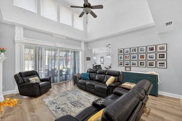 a kitchen with kitchen island granite countertop a sink a island a counter and chairs