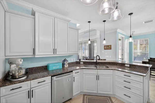 a dining room with furniture a chandelier and window