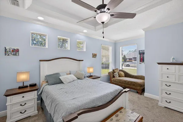 a bedroom with furniture and a flat screen tv