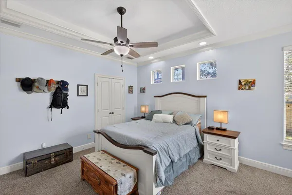 a bathroom with a tub a sink double vanity and a mirror