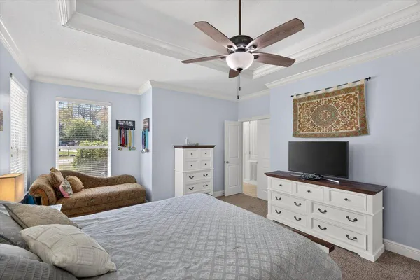 a living room with furniture and a book shelf